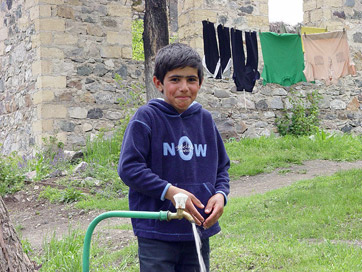 A little boy playing with water in Nor-Getashen