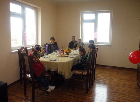 Artsakh Housing - A large family around table in their newly built house